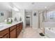 Large bathroom with double vanity, soaking tub, and glass shower offers a spa-like experience at 7584 Oakberry Dr, Raleigh, NC 27616