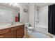 Well-lit bathroom with a wooden vanity and a combined bathtub/shower featuring a modern shower head at 7584 Oakberry Dr, Raleigh, NC 27616