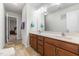 Bathroom featuring a double sink vanity with wooden cabinets and a large mirror for a bright, open feel at 7584 Oakberry Dr, Raleigh, NC 27616