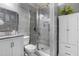 Modern bathroom features a sleek glass-enclosed shower, stylish vanity, and sophisticated gray tiling at 7584 Oakberry Dr, Raleigh, NC 27616