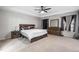 Modern bedroom with stylish wood furniture, including a bed, nightstand, and dresser, all on plush carpet at 7584 Oakberry Dr, Raleigh, NC 27616