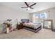 Bedroom with a gray bed, ceiling fan, and large windows providing natural light at 7584 Oakberry Dr, Raleigh, NC 27616