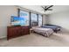 Bedroom featuring carpet, dresser, television, and two beds beneath a ceiling fan and natural light at 7584 Oakberry Dr, Raleigh, NC 27616