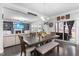 Charming dining area with a large wooden table, comfortable seating, and sliding door to the outdoor patio at 7584 Oakberry Dr, Raleigh, NC 27616