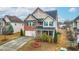 Lovely two-story house with brick accents, vinyl siding, a long driveway, and well-maintained landscaping at 7584 Oakberry Dr, Raleigh, NC 27616