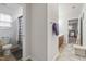Hallway connecting the toilet and shower to the double sink vanity and a bedroom with carpeted floors at 7584 Oakberry Dr, Raleigh, NC 27616