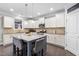 Modern kitchen with white cabinets, granite countertops, a center island with seating, and stainless steel appliances at 7584 Oakberry Dr, Raleigh, NC 27616