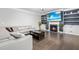 Cozy living room with a fireplace, built-in shelves, a large TV, and comfortable seating at 7584 Oakberry Dr, Raleigh, NC 27616