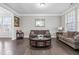 Cozy living room with hardwood floors, neutral decor, and ample seating for relaxation and entertainment at 7584 Oakberry Dr, Raleigh, NC 27616