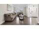 Elegant living room featuring hardwood floors, natural light, and comfortable seating arrangements at 7584 Oakberry Dr, Raleigh, NC 27616