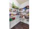 Well-stocked walk-in pantry featuring ample shelving and organization for convenient storage at 7584 Oakberry Dr, Raleigh, NC 27616