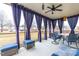 Inviting screened-in patio area with outdoor seating and privacy curtains at 7584 Oakberry Dr, Raleigh, NC 27616
