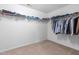 Spacious walk-in closet with carpet and wire shelving, providing ample storage for clothing and accessories at 7584 Oakberry Dr, Raleigh, NC 27616