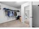 Walk-in closet with carpet and wire shelving, connected to the bathroom through an open doorway at 7584 Oakberry Dr, Raleigh, NC 27616