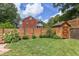 Backyard featuring lawn space, mature trees, landscaping, and a privacy fence at 800 E Forest Hills Blvd, Durham, NC 27707