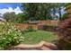 Backyard featuring a lawn, landscaping, privacy fence, and a detached building at 800 E Forest Hills Blvd, Durham, NC 27707