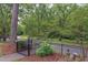 Beautifully landscaped backyard with a black metal fence and lush greenery at 800 E Forest Hills Blvd, Durham, NC 27707