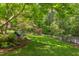 Serene backyard with a hammock, lush lawn, and privacy fence at 800 E Forest Hills Blvd, Durham, NC 27707