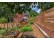 Backyard featuring a garden area, landscaping, privacy fence, and detached building at 800 E Forest Hills Blvd, Durham, NC 27707