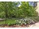 Lush backyard with manicured landscaping and a black metal fence at 800 E Forest Hills Blvd, Durham, NC 27707