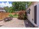 Backyard featuring a stone patio, landscaping, privacy fence, and a detached building at 800 E Forest Hills Blvd, Durham, NC 27707