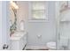 Charming bathroom with marble vanity, updated fixtures, and a glass-enclosed shower for a modern touch at 800 E Forest Hills Blvd, Durham, NC 27707