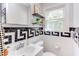 Bathroom with mosaic tile accent, large sink and floating shelves at 800 E Forest Hills Blvd, Durham, NC 27707