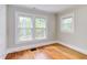 Bedroom featuring hardwood floors, and multiple windows at 800 E Forest Hills Blvd, Durham, NC 27707