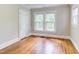 Bedroom with hardwood floors, white trim, and large windows at 800 E Forest Hills Blvd, Durham, NC 27707