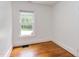 Bedroom featuring hardwood floors and single window at 800 E Forest Hills Blvd, Durham, NC 27707