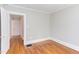 Bedroom with hardwood floors, white trim, and doorway at 800 E Forest Hills Blvd, Durham, NC 27707
