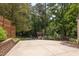 Spacious driveway leading to a beautiful backyard with mature trees at 800 E Forest Hills Blvd, Durham, NC 27707