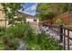 Well-maintained home exterior with blooming flowers and a manicured lawn at 800 E Forest Hills Blvd, Durham, NC 27707