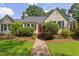 Charming single-story home with manicured lawn and a welcoming front porch and mature landscaping at 800 E Forest Hills Blvd, Durham, NC 27707