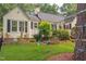 Front yard featuring a lovely lawn, mature landscaping and play equipment at 800 E Forest Hills Blvd, Durham, NC 27707