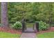 Charming gated entrance with black ironwork and lush greenery leading to a park trail at 800 E Forest Hills Blvd, Durham, NC 27707