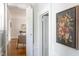 Bright hallway featuring hardwood floors, white trim, and stylish artwork creating a warm welcome at 800 E Forest Hills Blvd, Durham, NC 27707