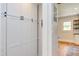 Bright hallway featuring hardwood floors and white custom cabinetry for ample storage, next to an open doorway at 800 E Forest Hills Blvd, Durham, NC 27707