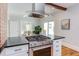 Modern kitchen with stainless steel gas range, white cabinets and stone countertops at 800 E Forest Hills Blvd, Durham, NC 27707