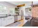 Modern kitchen with white cabinetry, subway tile backsplash, stainless steel appliances, and open shelving at 800 E Forest Hills Blvd, Durham, NC 27707