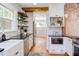 Kitchen with subway tile, floating shelves, stainless steel appliances and a farm sink at 800 E Forest Hills Blvd, Durham, NC 27707