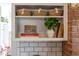 Decorated shelving featuring decorative baskets and cookbooks at 800 E Forest Hills Blvd, Durham, NC 27707