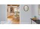 Open-concept kitchen and dining area featuring hardwood floors, white cabinetry, and a modern dining set at 800 E Forest Hills Blvd, Durham, NC 27707