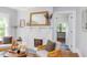 Bright living room with fireplace, comfortable chairs, and view to another room at 800 E Forest Hills Blvd, Durham, NC 27707