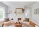 Cozy living room with a white-painted fireplace, decorative mirror, and comfortable seating with a patterned rug at 800 E Forest Hills Blvd, Durham, NC 27707