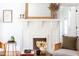 Cozy living room showcasing a decorative white brick fireplace with wooden mirror and stylish decor accents at 800 E Forest Hills Blvd, Durham, NC 27707