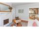 Charming living room featuring a white brick fireplace, comfortable seating, and an open view to the kitchen at 800 E Forest Hills Blvd, Durham, NC 27707