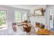 Bright living room with white sofa, decorative fireplace, and lots of natural light from a large window at 800 E Forest Hills Blvd, Durham, NC 27707