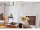 Beautiful living room featuring a white brick fireplace, complemented by a modern coffee table with decorative items at 800 E Forest Hills Blvd, Durham, NC 27707