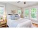 Bright bedroom with ample natural light, ceiling fan, and inviting bed with stylish bedside tables at 800 E Forest Hills Blvd, Durham, NC 27707